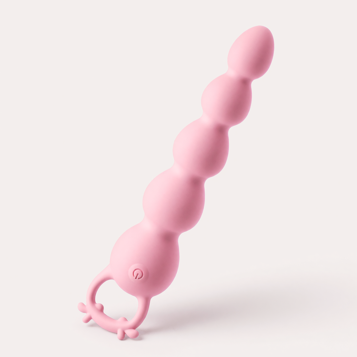 Hirni massager standing at an angle, showing the power button